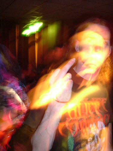 Motion-blurred concert candid in orange light