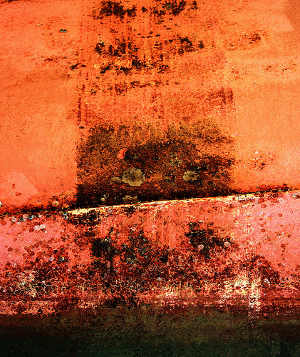 Rusted orange and black painted ship hull