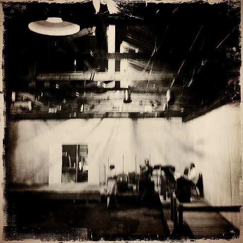 Blurred sepia factory interior with hanging lamp