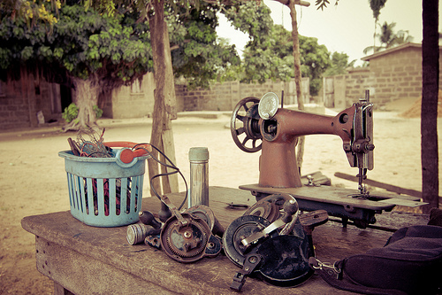 Old sewing machine and parts on an outdoor table