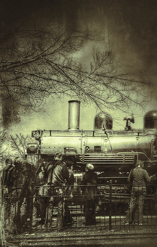 Vintage steam locomotive with onlookers, textured monochrome