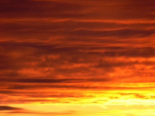 Banded orange clouds at sunset