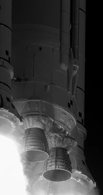 Close view of rocket engines and a bright exhaust plume.