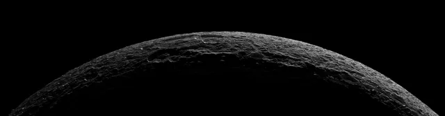 A thin illuminated arc revealing the surface of an icy moon.