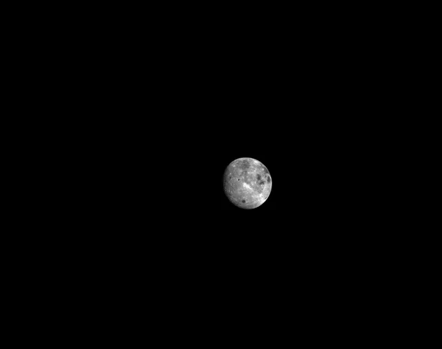 A small moon with visible surface detail surrounded by black space.